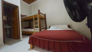 a bedroom with a bed and a bunk bed at La Jangada Hostel & Tours in Leticia