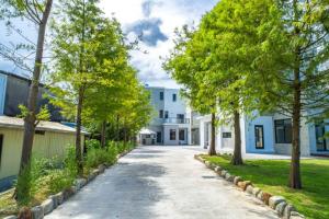 a street in a residential neighborhood with trees and houses at Wei Yu's Home Villa in Dongshan