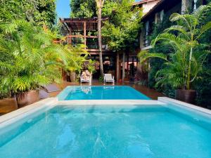 a large swimming pool in the middle of a house at Pousada Agua de Coco in Arraial d'Ajuda