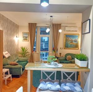 a living room with a couch and a table at Gracia apartment - old town Belgrade in Belgrade