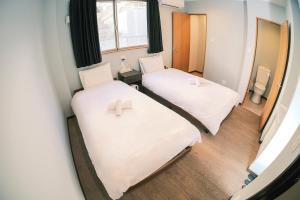 Postel nebo postele na pokoji v ubytování ホテルハーバー心斎橋