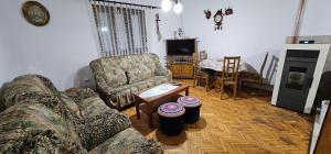 a living room with two couches and a table at House Vidakovic in Kolašin