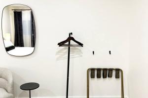 a room with a mirror and a coat rack at King Bed, The Phenix Historic DWTN Hotel, Room # 304 in Bangor