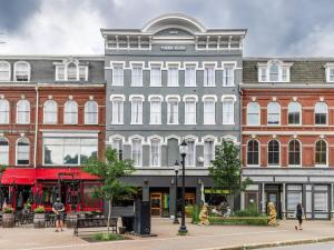 a large building with people walking in front of it at King Bed, The Phenix Historic DWTN Hotel, Room # 304 in Bangor