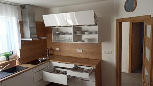 a kitchen with white cabinets and a sink at Apartmány Volavka in Planá nad Lužnicí