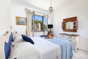 a bedroom with a bed and a window at Villa Simba in Massa Lubrense +33 photos