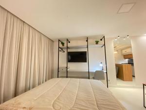 a bedroom with a large bed in a room at Flat Home Business 202 Centro Pomerode in Pomerode