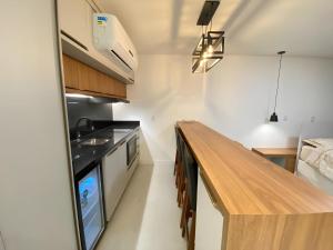 a kitchen with a wooden counter top in a room at Flat Home Business 202 Centro Pomerode in Pomerode