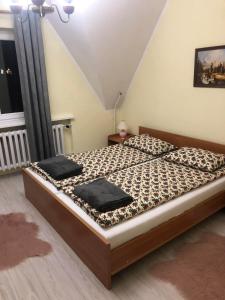 a bedroom with a bed with two pillows on it at Apartament Joanna in Poronin