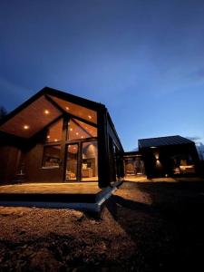 a house with a large window on the side of it at Nybygget arkitekt tegnet Snøhetta i vakker natur in Sand