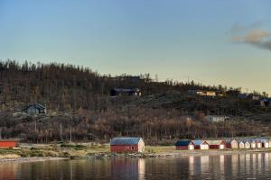 a group of houses on the shore of a body of water at Nybygget arkitekt tegnet Snøhetta i vakker natur in Sand