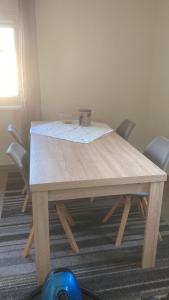 a wooden table with chairs in a room at Ferienwohnung Christel in Erlenbach am Main