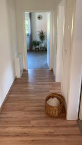 a hallway with a basket on a wooden floor at Ferienwohnung Christel in Erlenbach am Main