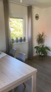 a dining room with a table and chairs and a window at Ferienwohnung Christel in Erlenbach am Main