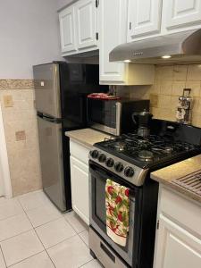 a kitchen with a stove and a refrigerator at Mountain Creek Condo, Chic, comfy Vernon NJ in Vernon Township