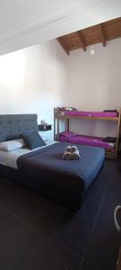 a bedroom with a large bed with shoes on it at Güemes Hostel Cordoba in Córdoba