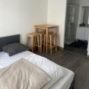 a bedroom with a bed and a table and two tables at Room in Guest room - Home - Chambre independante a 10min Rer C et de Dourdan in Sermaise