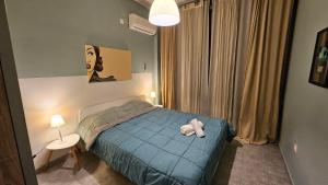 a bedroom with a bed with a teddy bear on it at A Place 4 U no22 in Athens