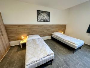 a room with two beds and a table with lights at Hotel Hangar in Mošnov