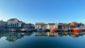 a group of boats are docked in a harbor at Alexandra Hotel in Weymouth