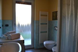 a bathroom with a sink and a toilet and a window at ElleCi Casa Vacanze in Mondovì