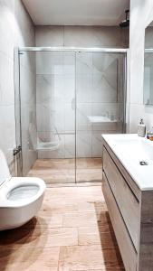 a bathroom with a shower and a toilet and a sink at 360 Nicosia Heights, Gym & Pool in Nicosia +16 photos
