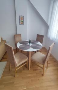 a dining room table and chairs in a room at Sunny Guest House in Skopje