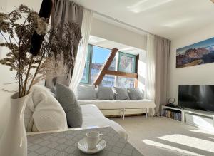 a living room with a couch and a large window at Bergblick-Lounge zentral in Immenstadt in Immenstadt im Allgäu