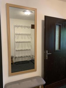 a mirror in a room with a door and a closet at Chata na lúke in Tatranska Strba