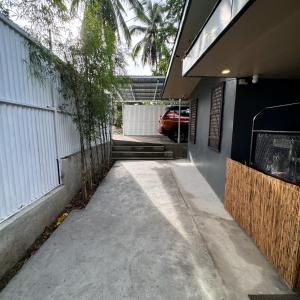 a driveway to a house with a car in the garage at The Orchard Private Villa with Pool and Wifi in Cuenca Batangas in Cuenca