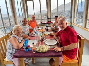 a group of people sitting at a table eating food at Casa Adriano & Filomena Montrond in Portela