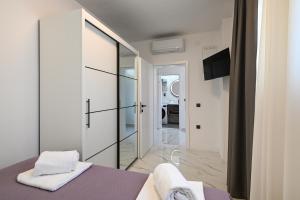 a bedroom with a bed and a sliding glass door at Luxury Apartment Gloria Old Town Zadar with Sea View in Zadar