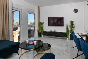 a living room with a couch and a table at Luxury Apartment Gloria Old Town Zadar with Sea View in Zadar