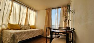 a bedroom with a bed and a table and a window at Personal Aparts Bellas Artes in Santiago +56 photos