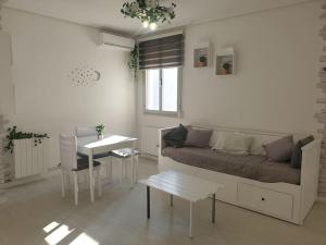 a living room with a couch and a table at Apartamento Eguzkilore. Logroño in Logroño