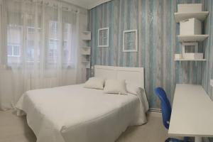 a bedroom with a white bed and a window at Apartamento Eguzkilore. Logroño in Logroño