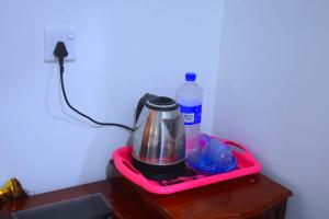 a blender on a table next to a bottle of water at Lodge In The Valley Udawalawa in Udawalawe
