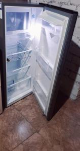 an empty refrigerator with its door open in a room at Lunahuaná CASA DE CAMPO PAULLU in Lunahuaná