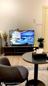 a living room with a large flat screen tv at استديو بأثاث انيق -النقرة in Hail