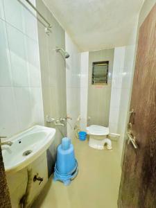 a bathroom with a toilet and a sink at GRK Hotel - Near Shri Saibaba Temple in Shirdi
