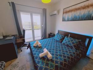 a bedroom with a bed and a desk and a window at STAY Kallipoleos Apartment in Nicosia