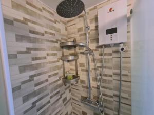 a shower in a bathroom with wooden tiles at STAY Kallipoleos Apartment in Nicosia