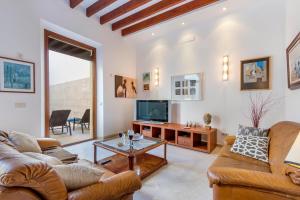 a living room with two couches and a tv at Sa Marilyn - Can Campins in Sa Pobla