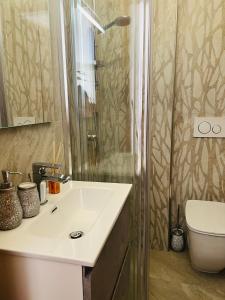 a bathroom with a sink and a shower at Cucù home in Pisa
