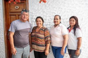 a group of people standing in front of a door at Hotel LA GRAN TORTUGA - ᯤ STARLINK in Puerto Villamil