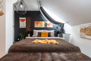 a bedroom with a bed with a blanket on it at Spacious flat & parking possibility, 3 stops to Wenceslav square in Prague