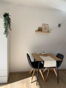 a dining room with a table and two chairs at Ferienwohnung Panorama Schwarzwald in Herrischried +4 photos