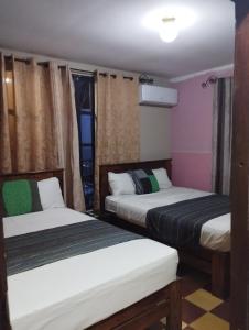 Rúm í herbergi á HOTEL EL ALMENDRO