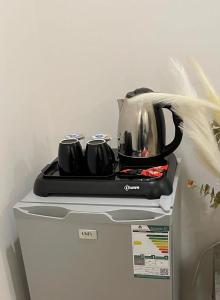 a tea kettle is sitting on top of a refrigerator at استديو بأثاث انيق -النقرة in Hail