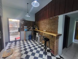 a kitchen with a counter and a checkered floor at Punkei home-Chiang Mai Center Near Sunday Market in Chiang Mai